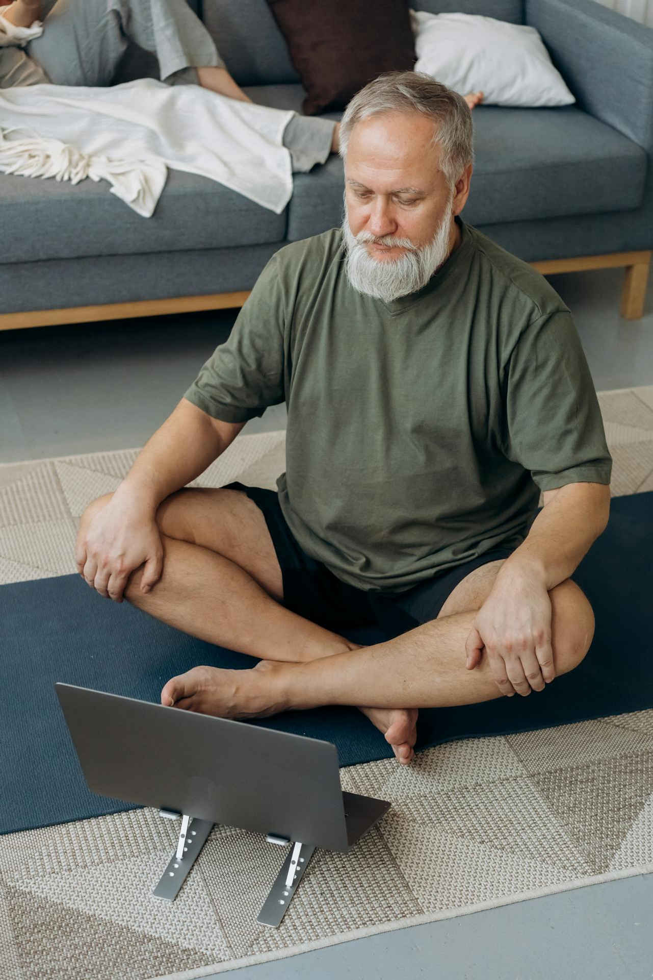 a man sitting in a chair in front of a laptop