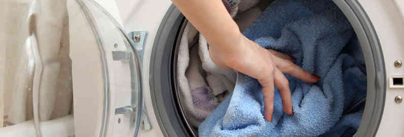 a person putting clothes in a washing machine