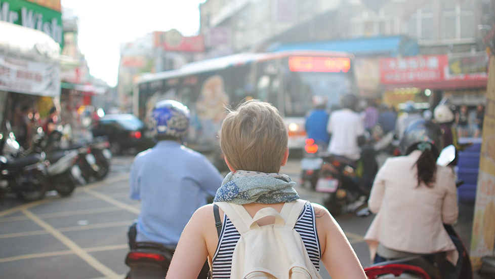 a woman walking down a busy city street