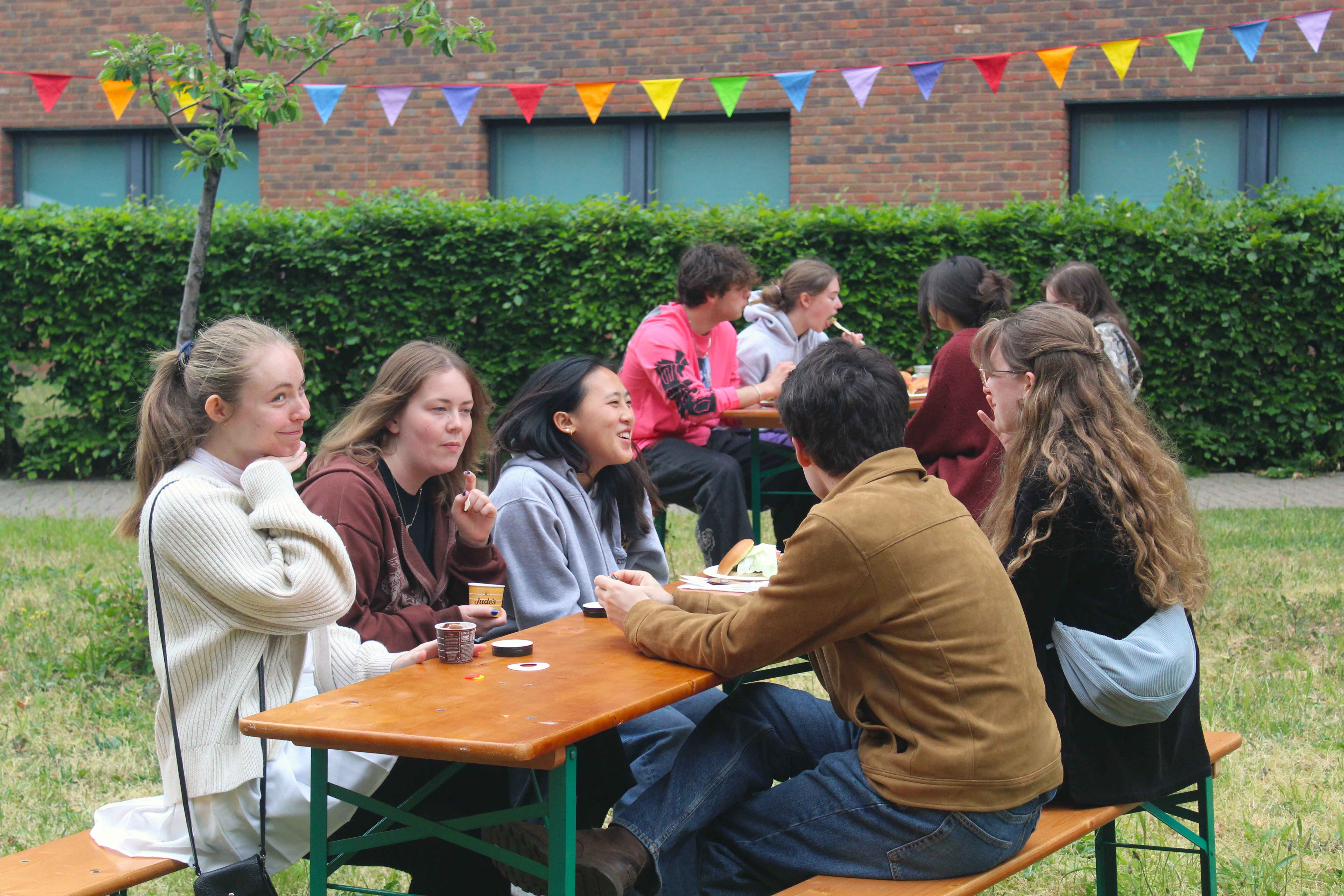 a group of people sitting at a picnic table