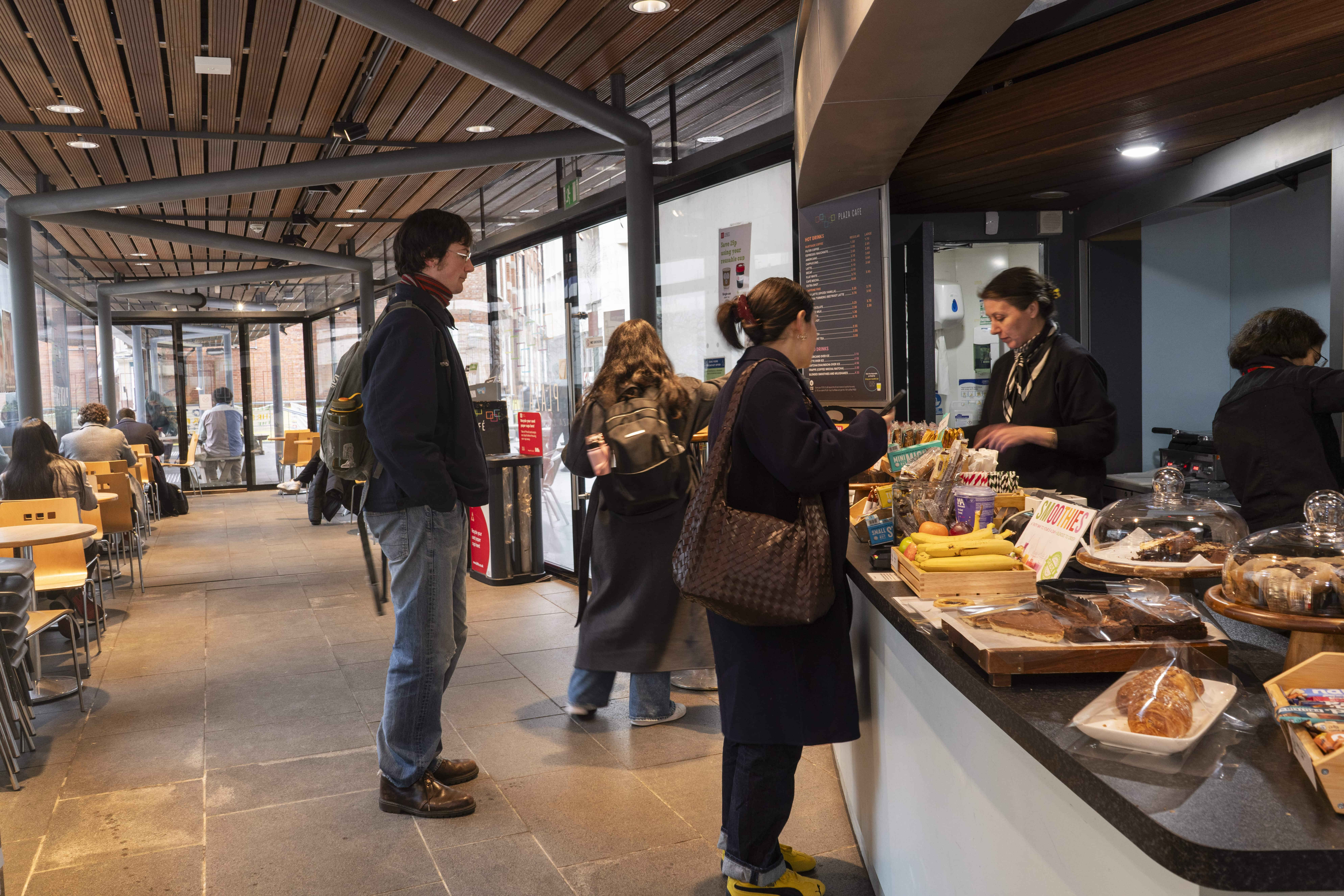 a group of people standing at a cafe