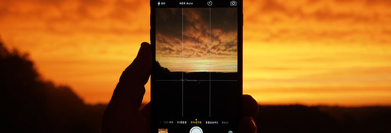 a screenshot of a cell phone in front of a sunset