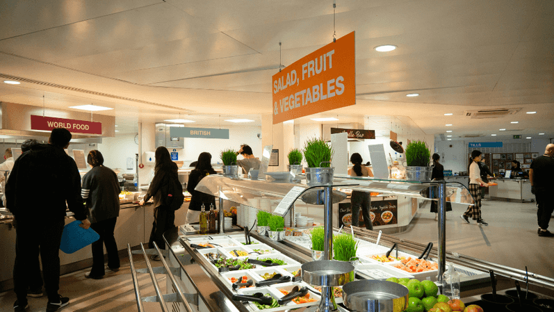a group of people standing in a restaurant