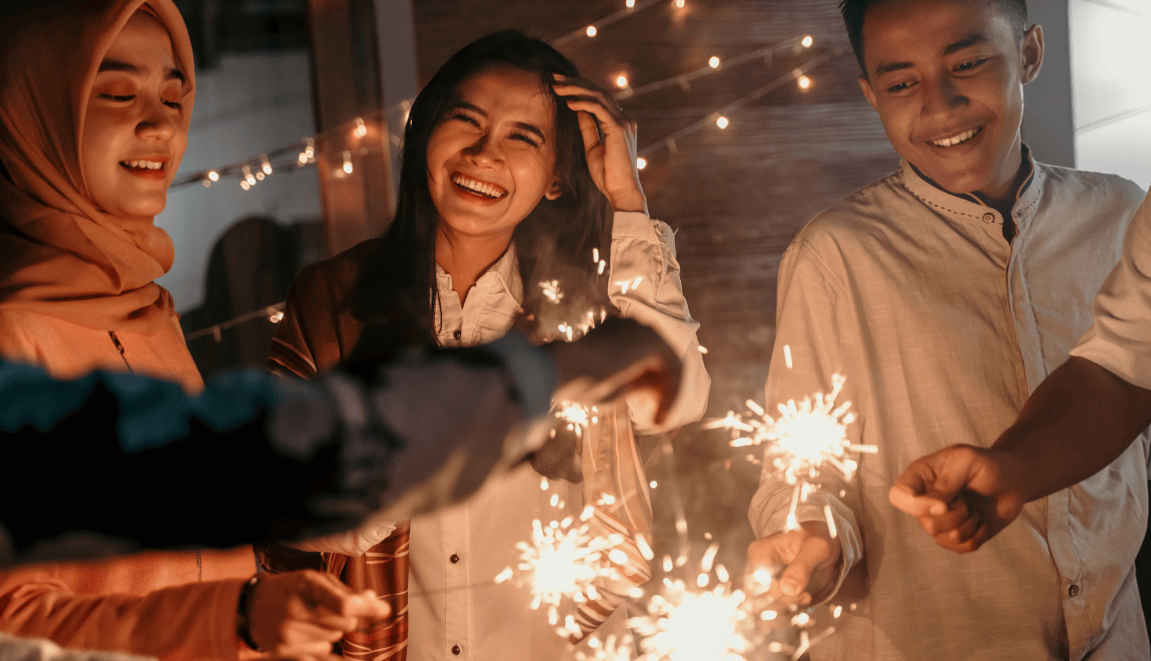 people celebrating with sparklers