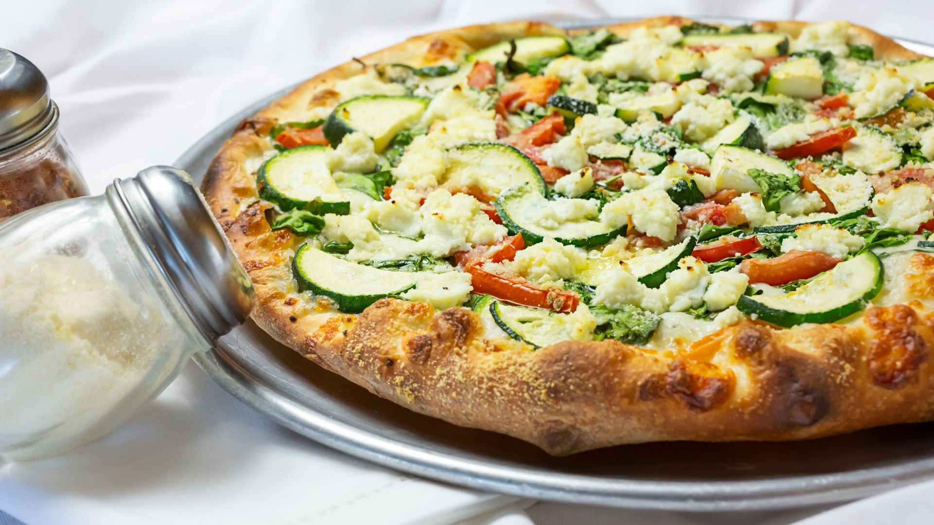 a pizza sitting on top of a plate of food