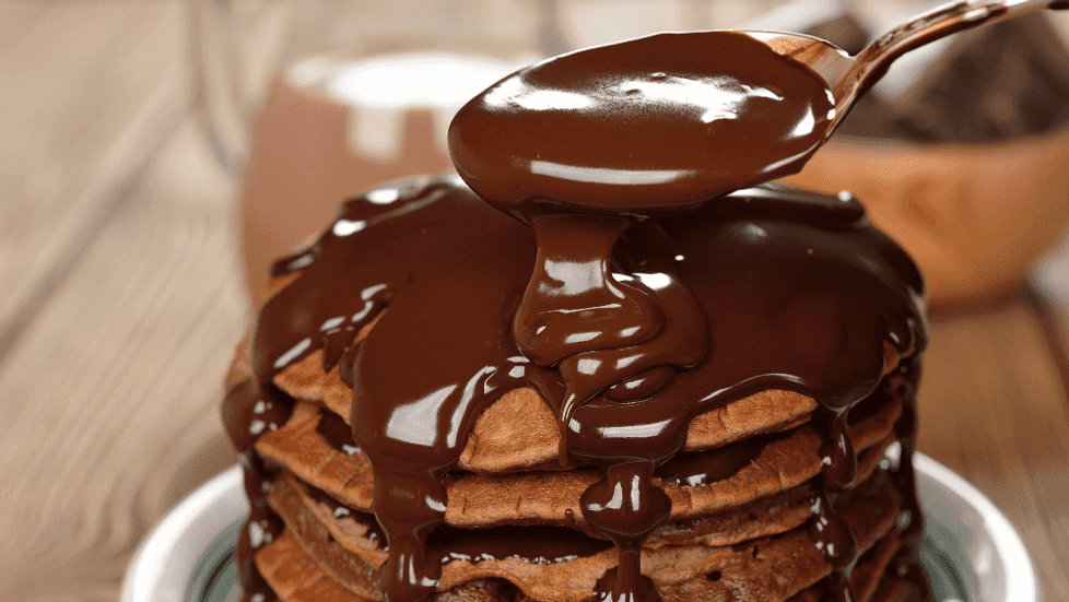 pancakes being covered in chocolate