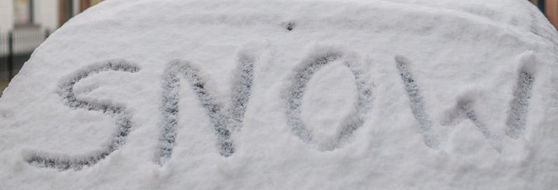 a close up of a sign written in snow on a car