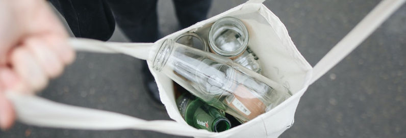 a person with a bottle in a bag