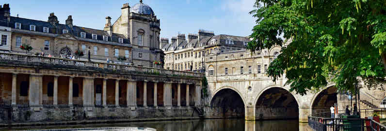 a large bridge over some water with Bath in the background